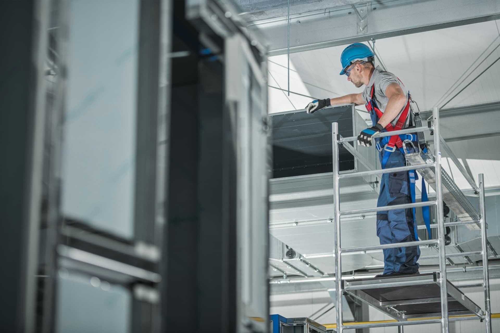 HVAC technician working on commercial equipment.