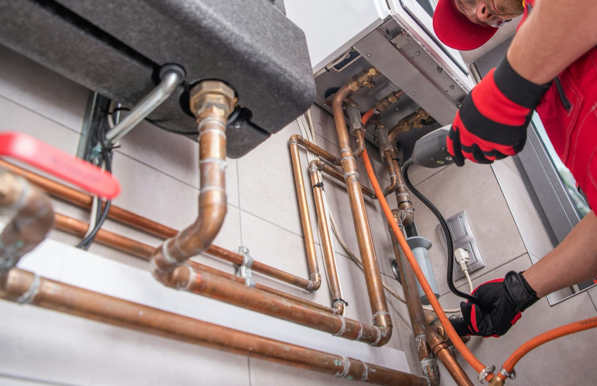 Technician working on copper piping for heating equipment.